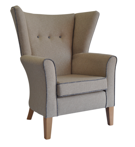 Wing armchair in beige coloured fabric with 3 buttons on the back and brown piping